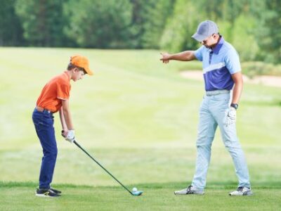 young golfer receiving instruction